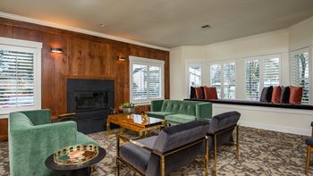 a living room with couches and chairs and a fireplace